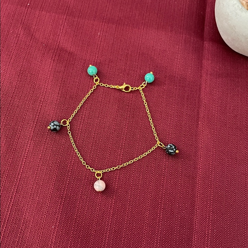 Delicate bracelet with 5 beaded gemstones.